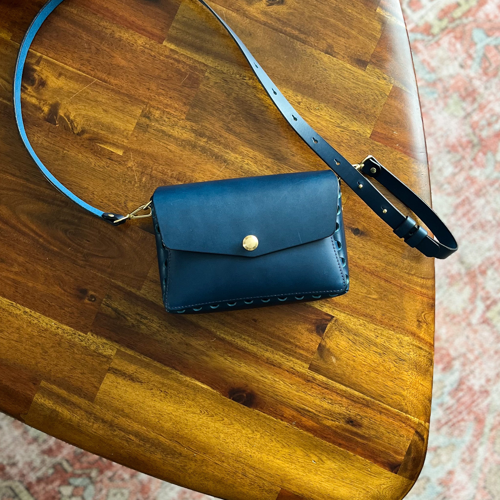 modjūl's petit leather crossbody bag in blue, made in canada