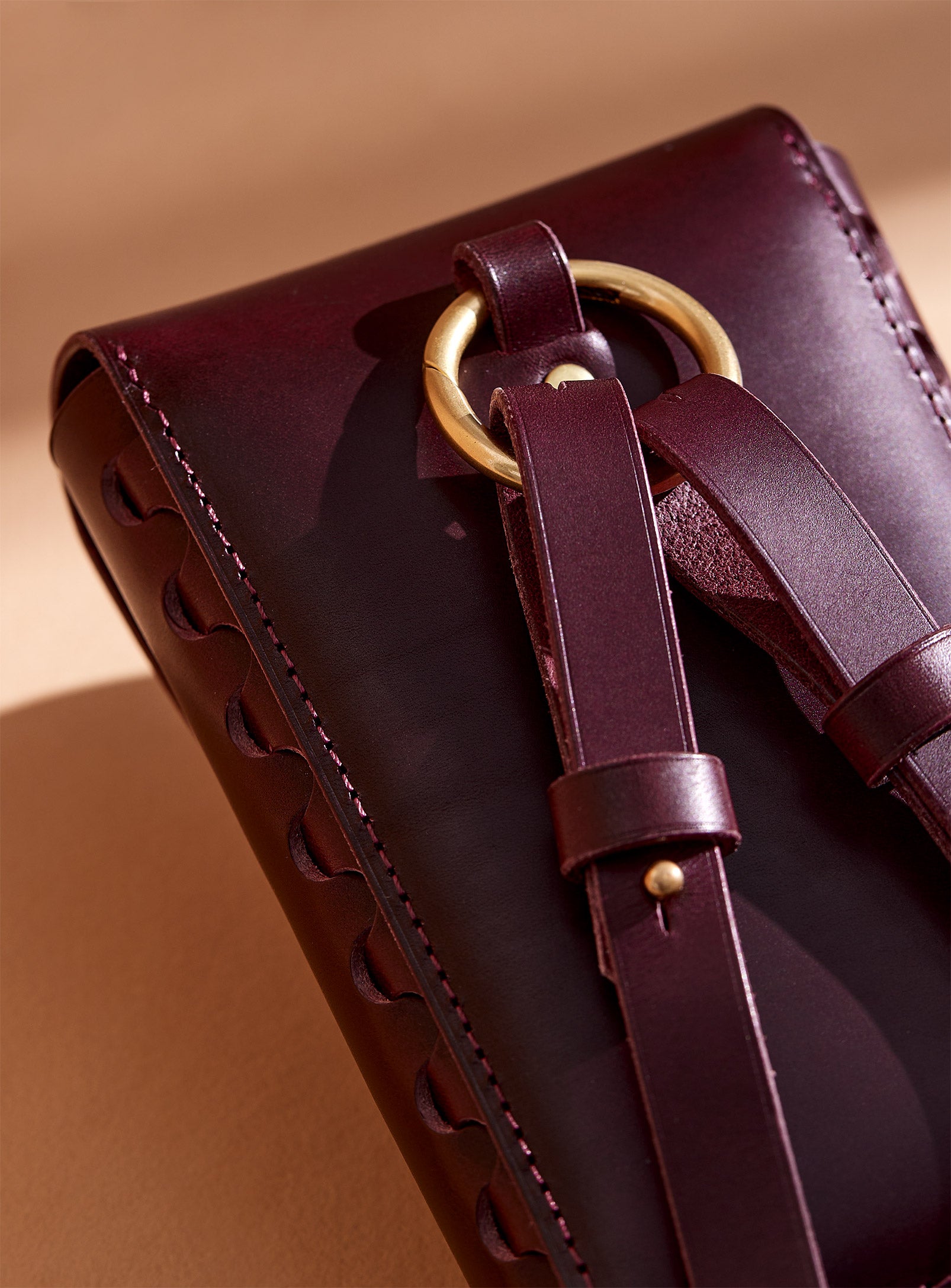 A close up of the back of modjūl's leather capsule bag.