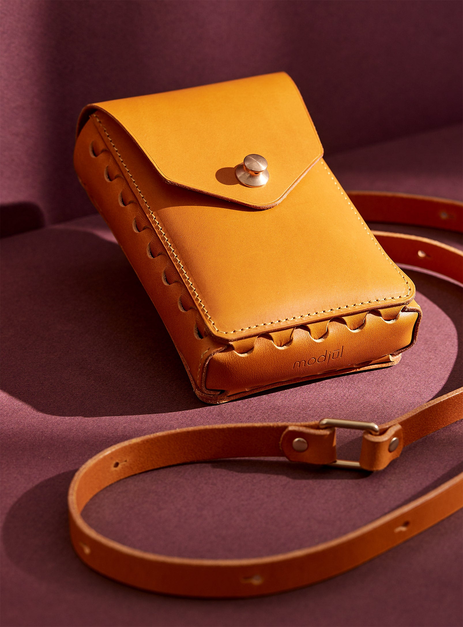 modjūl capsule leather bag in yellow. A rectangular shaped leather bag with a long strap, perfect for a phone.