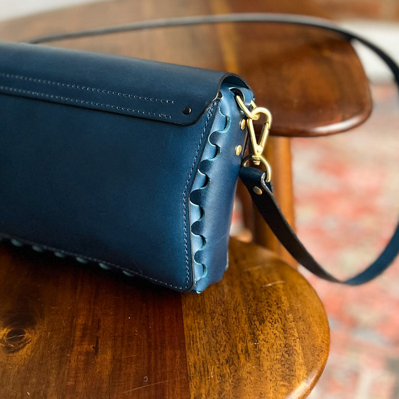 back of modjūl's petit leather crossbody bag in blue, made in canada