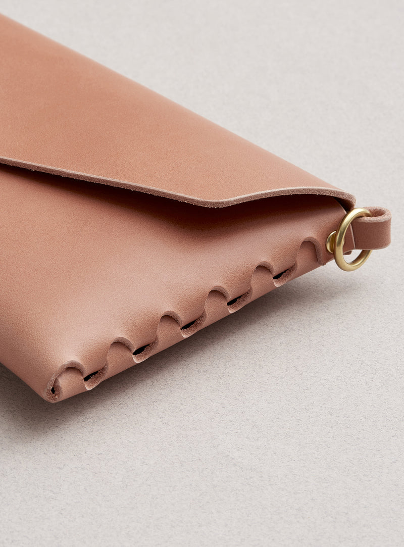 A close-up look at modjūl's signature joinery on the pink quality made leather mini bag. Handmade in Newfoundland Canada.