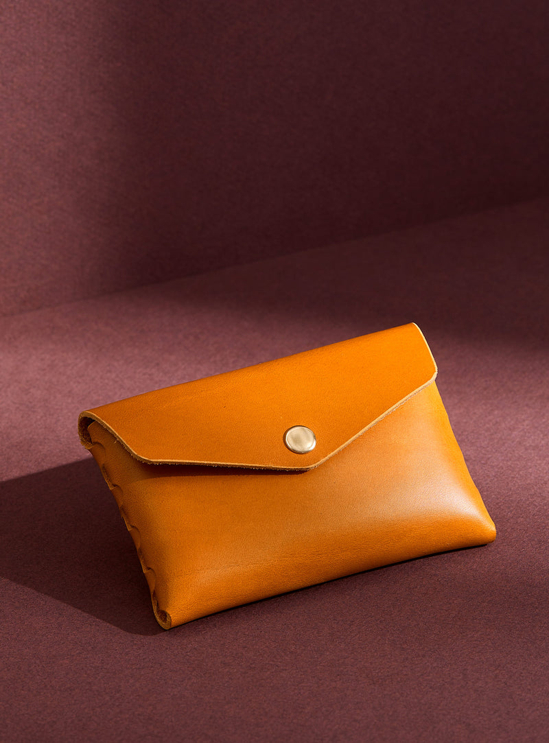 modjūl's classic pouch in yellow leather. A compact open wallet with endless possibilities, perfect for holding cards, keys or loose change. Handmade in Canada and joined with the signature modjūl joinery and quality brass hardware.