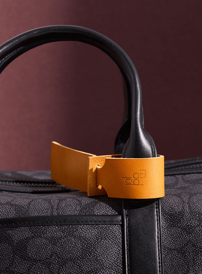 The modjūl leather traveller’s tag in yellow. A luggage tag constructed using quality vegetable-dyed Italian leather with the option for personalization.
