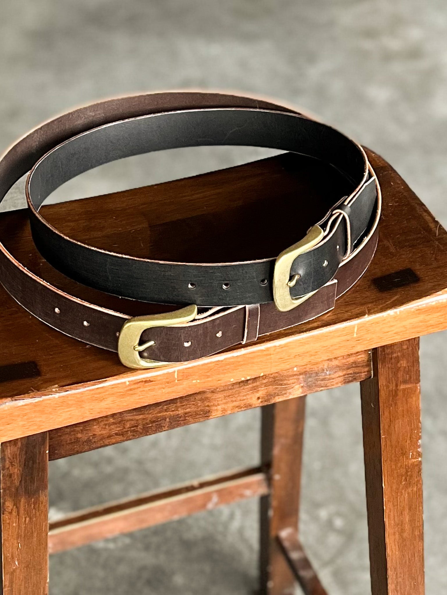modjūl premium leather belts in black and coffee, stacked. Handmade in Canada using Italian leather and quality hardware.