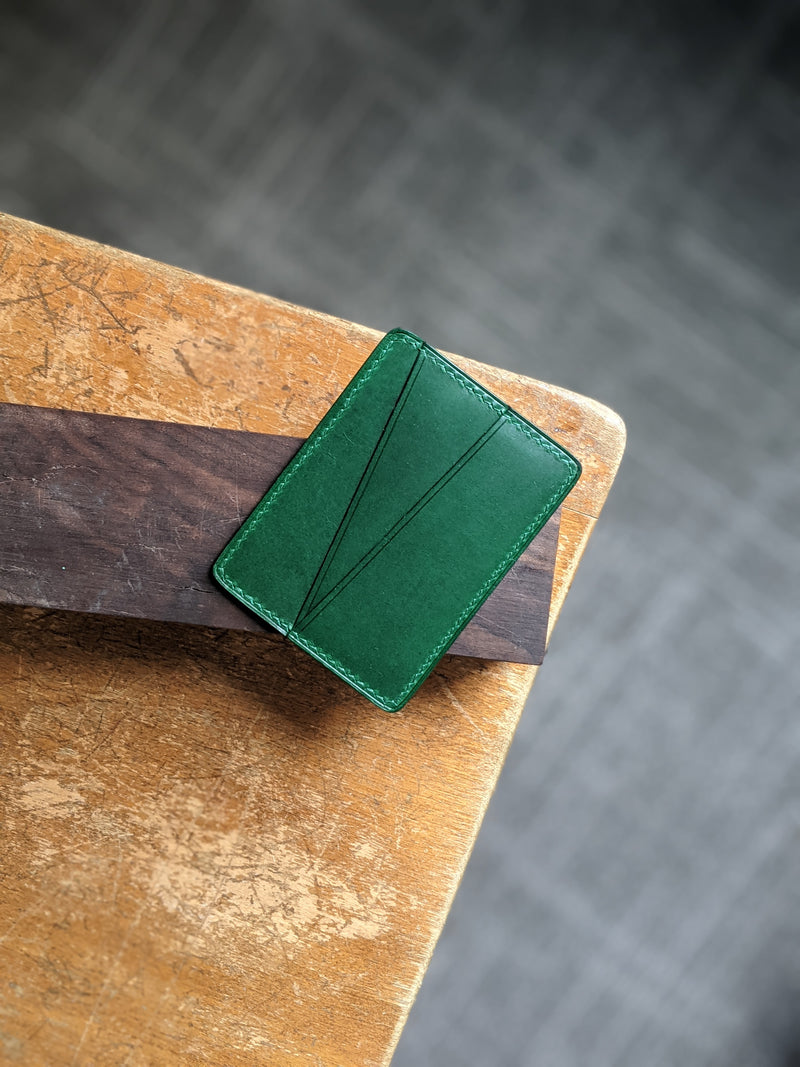 A front view of modjūl's quality made four pocket card holder wallet in green. Handmade in Canada.