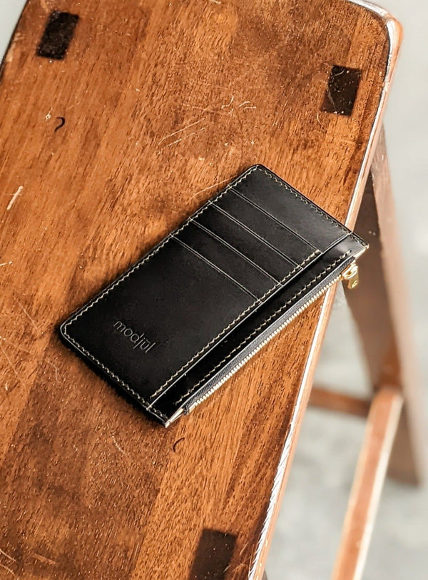 The short zip leather wallet in black designed and created by modjūl studio in Canada. Using quality leather this wallet can hold four cards and has a lined zip compartment.