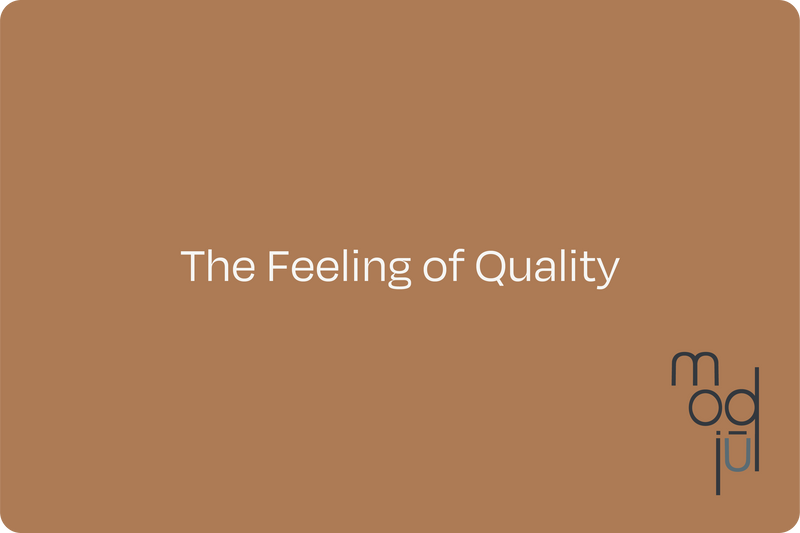 A brown virtual modjūl gift card that says "the feeling of quality".